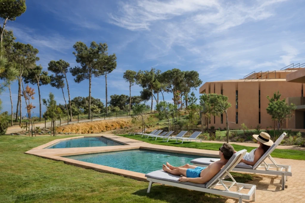 Outdoor pool and sun loungers at Palmares Signature Apartments in Lagos