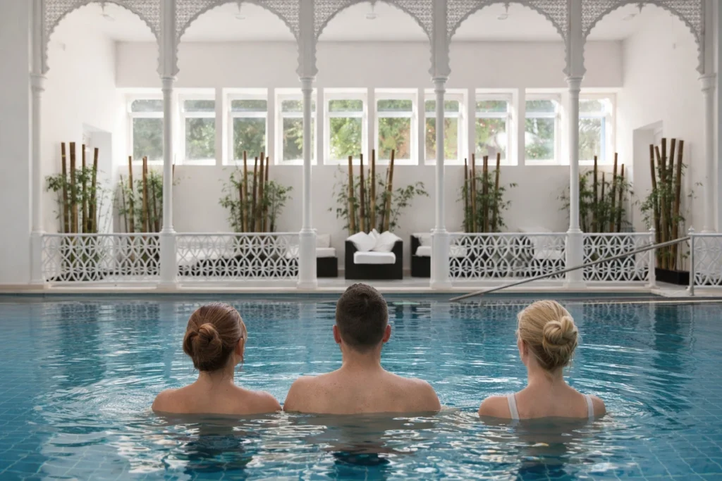 Guests relaxing in the indoor thermal pool at Termas do Luso